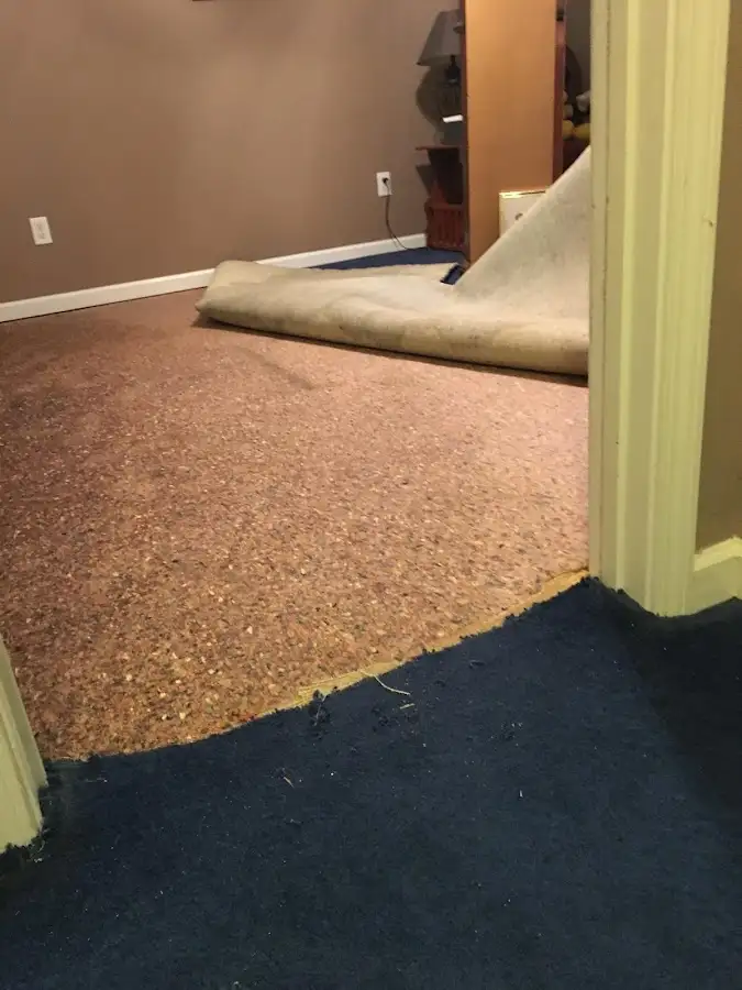 Carpet pad removal revealing water damage during Water Mitigation Services in North Hobbs